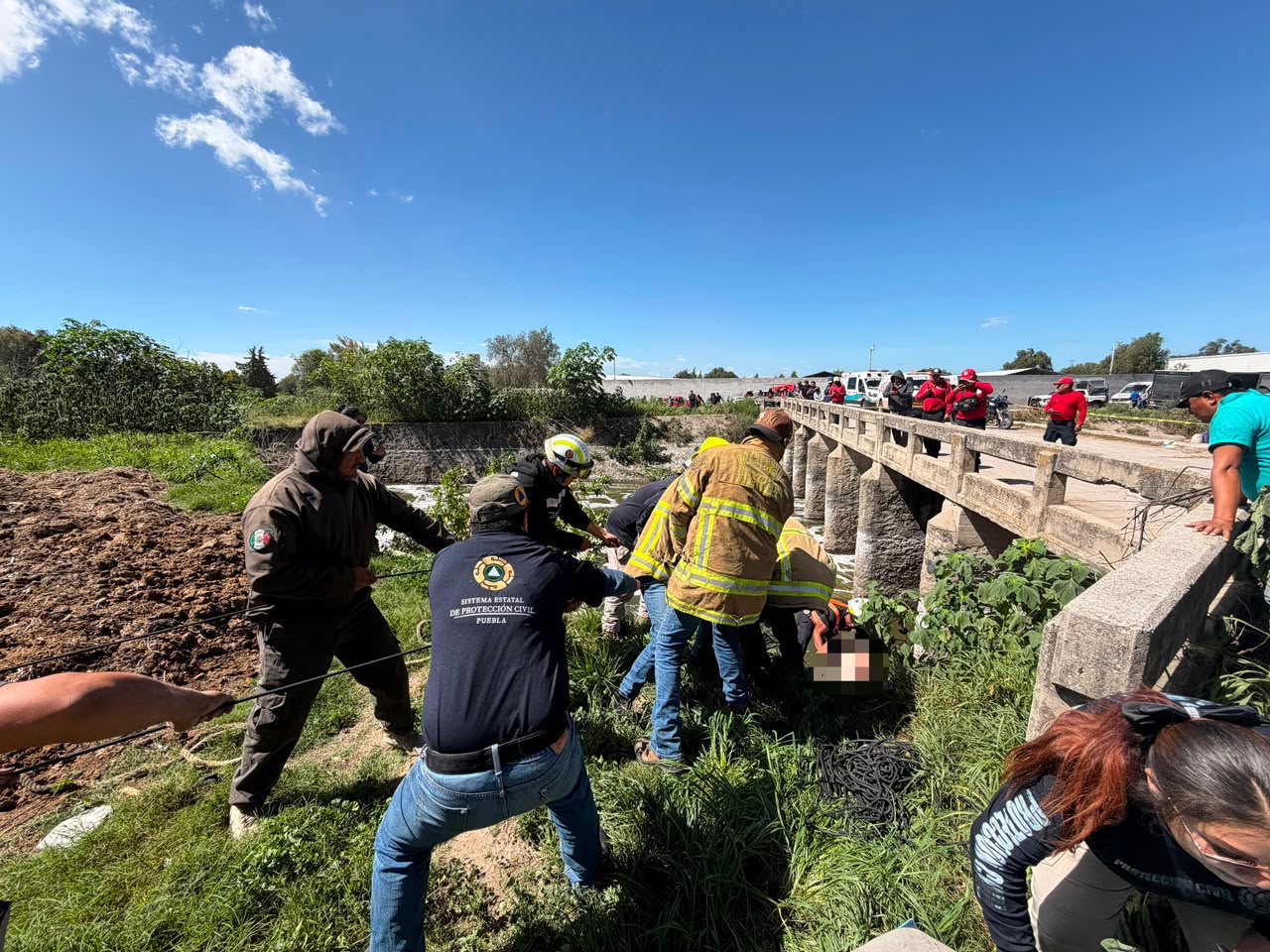 Personal de Protección Civil y corporaciones de emergencia durante las labores de búsqueda y recuperación de un cuerpo en el Canal de Valsequillo, en Tecamachalco.
